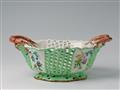 An oval faience basket with floral decor - image-1