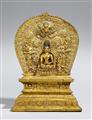 A Tibetan gilt bronze figure of Buddha Shakyamuni on an exremly rare gilt copper repoussé throne with aureole. 15th century - image-1