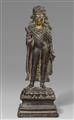 A rare Kashmiri or Western Tibetan silver-inlaid dark bronze figure of the crowned Buddha. 9th/10th century - image-1