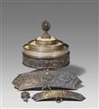 A Tibetan silver offering mandala, two silver-appliques and a silver-pendant - image-1