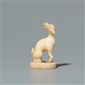 A walrus tooth netsuke of a dog on an oval base. Second half 19th century - image-1