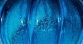 A blue glass bottle with ribbed decor - image-2