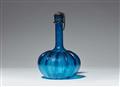 A blue glass bottle with ribbed decor - image-1