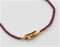 An 18k gold ruby necklace with a diamond clasp - image-2