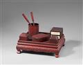 A set of writing objects on a table in the manner of carved red lacquer. 20th century - image-1