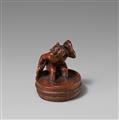 A wood netsuke of an oni washing himself. 19th century - image-1