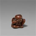 A boxwood netsuke of a boy with a Buaku mask. Mid-19th century - image-1