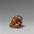 A boxwood netsuke of a shishi with cub. 19th century - image-1