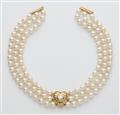 A cultured pearl necklace with an 18k gold heart set with a diamond solitaire. - image-1