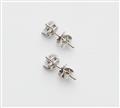 A pair of 18k white gold and diamond solitaire stud earrings. - image-2