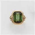 A 14k gold and green tourmaline ring. - image-1