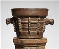 A large Gothic iron mortar on a wooden plinth - image-2