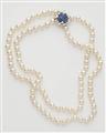 A two stranded cultured pearl necklace with an 18k gold sapphire and diamond clasp. - image-1