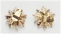 A pair of 14k gold and diamond snowflake clip earrings. - image-2