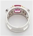 An 18k white gold diamond and synthetic pink sapphire three stone ring. - image-2