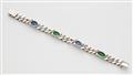 A Rhodium plated 18k yellow gold sapphire and emerald chain bracelet. - image-2