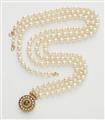 A German three stranded cultured pearl necklace with a circular 18k gold pearl and chrysoberyl cabochon clasp. - image-1