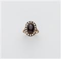 A 14k gold half pearl and carbuncle cabochon cluster ring. - image-1