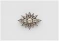 A small silver and cushion-cut diamond star brooch. - image-1