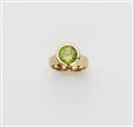 A German 18k gold and peridot ring. - image-1