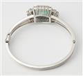 A German 14k white gold diamond and natural emerald bangle. - image-3