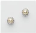 A pair of 14k white gold diamond and cultured pearl stud earrings. - image-1