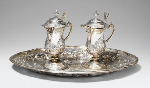 Franz Anton Lang - An Augsburg partially gilt silver communion garniture. Comprising wine and water jugs and a tray. With minor dents. Marks of Franz Anton Lang, 1767 - 69.