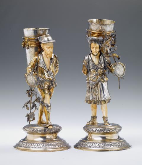 Gebrüder Gutgesell - A pair of Hanau silver figures of winegrowers. The busts, hands and legs of finely carved ivory. After a Nuremberg design from 1620. Marks of Gebrüder Gutgesell, ca. 1900.