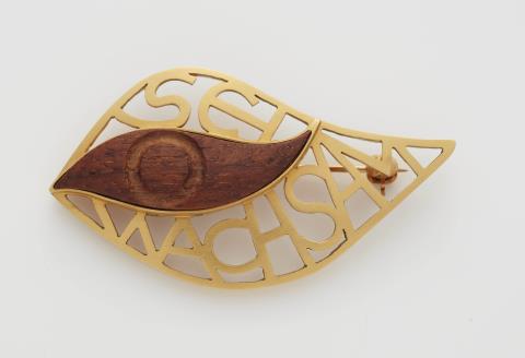Irmela Grigo - A German 14k gold and carved teak wood brooch.