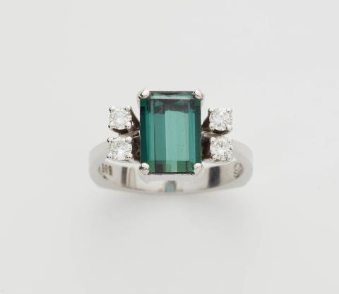 Irmela Grigo - A 14k white gold diamond and step-cut green tourmaline ring.