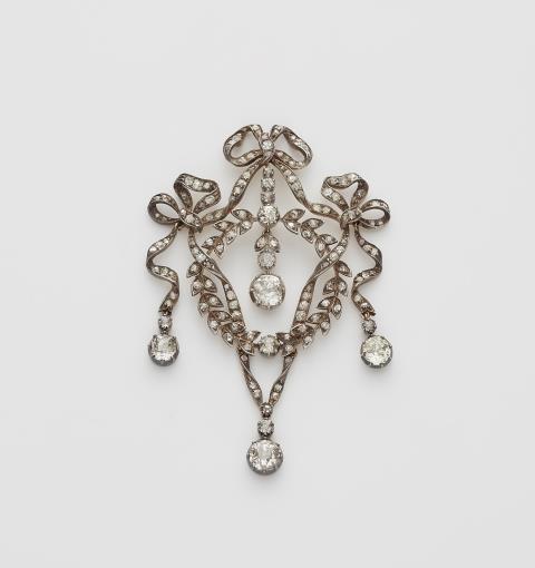 John Frazer & Edward Haws - An Edwardian silver 14k gold and diamond garland pendant with original case. Mountings lost.